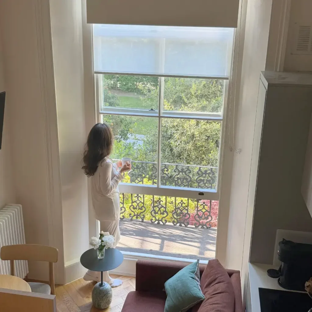 Kate from Your Planned Muse looking out the window from her kitchen
