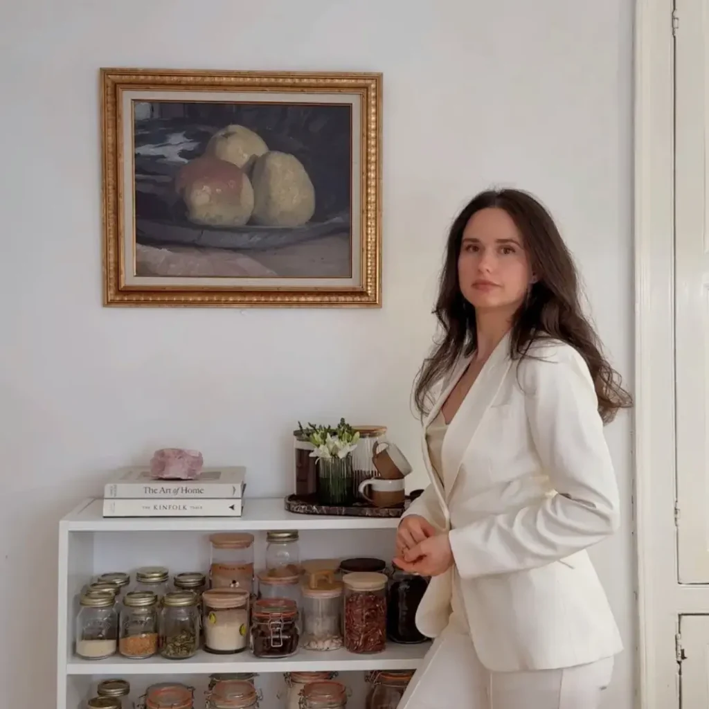 Kate from meal plan muse, standing in a kitchen in white suit.